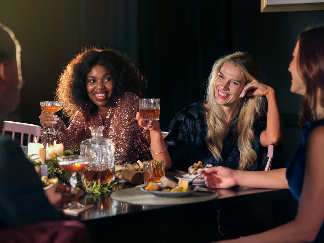 Friends laughing together over dinner