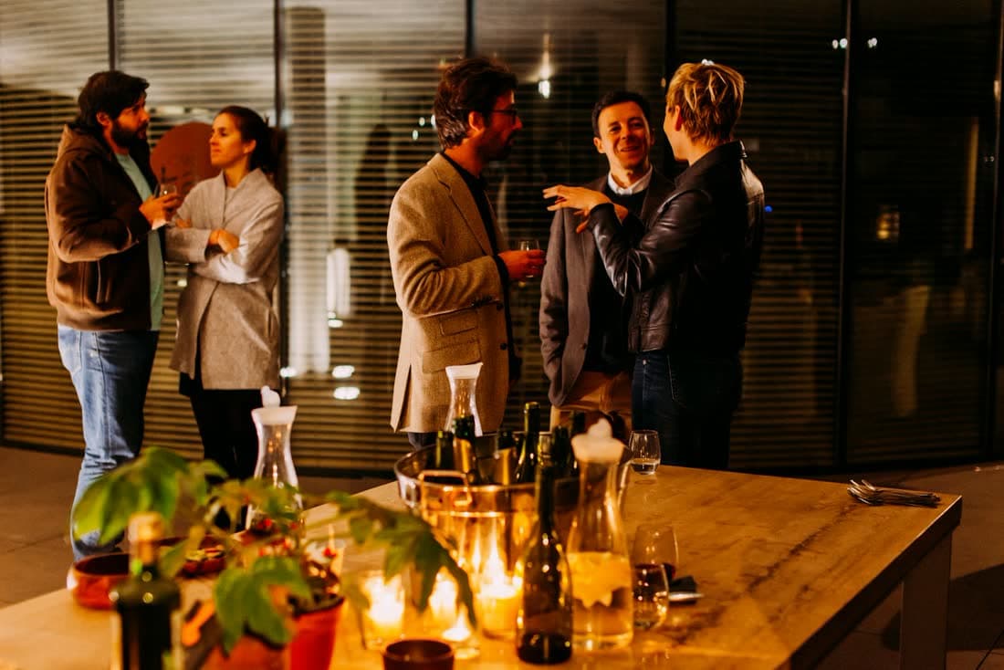People talking at an evening gathering